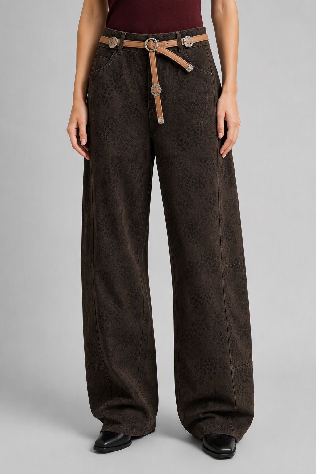 Front view of QAYQEY dark-brown leopard-jacquard curved-leg jeans with rope belt, floor-grazing hems
