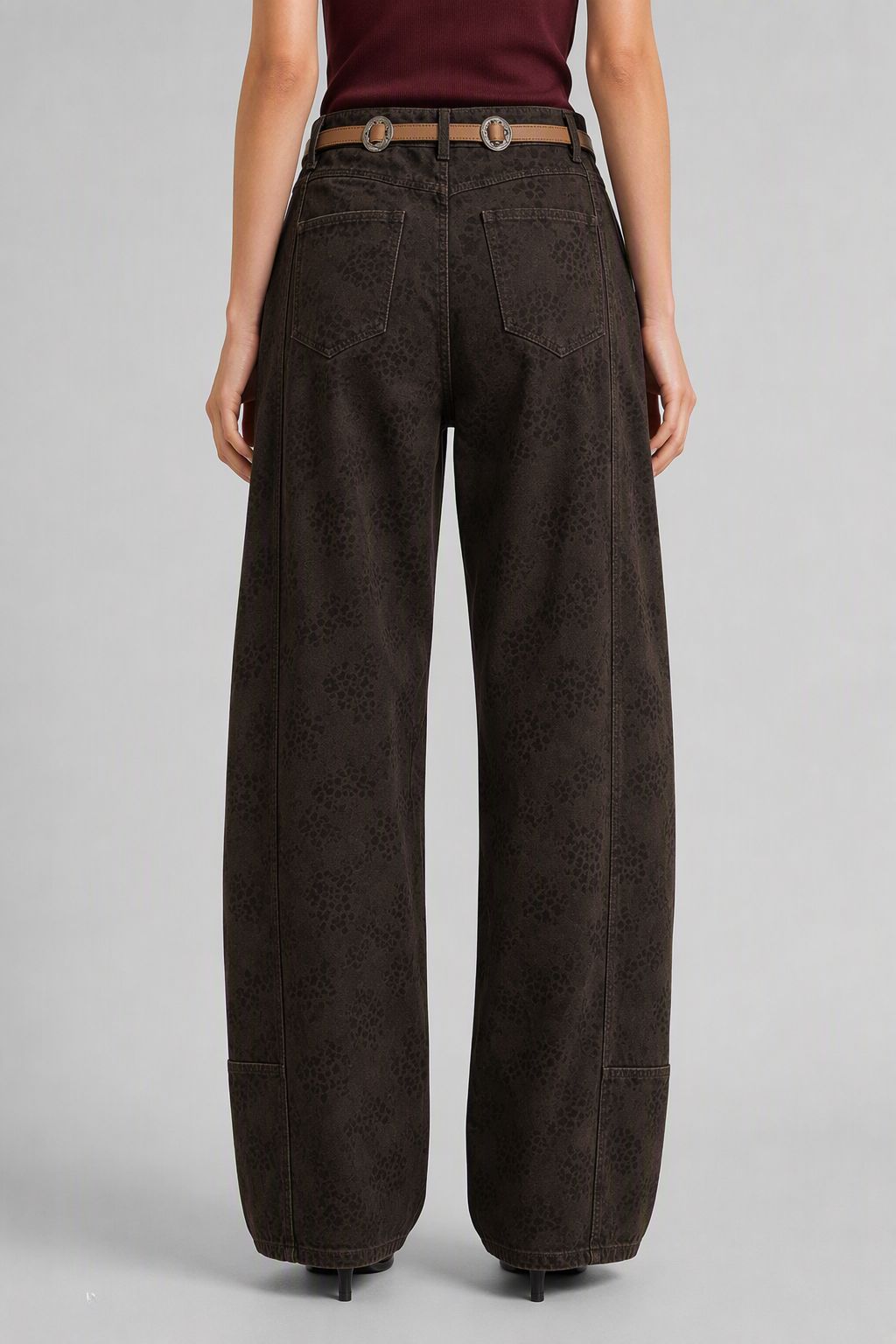 Back view of QAYQEY dark-brown leopard curved-leg jeans with patch pockets and rope belt detail