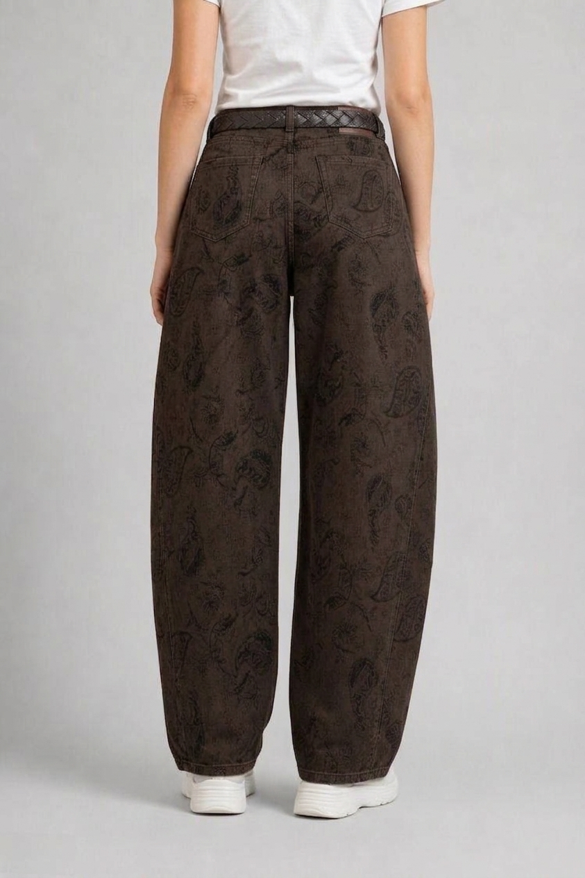 Back view of QAYQEY brown paisley-jacquard curved-leg jeans, waist-down crop on model