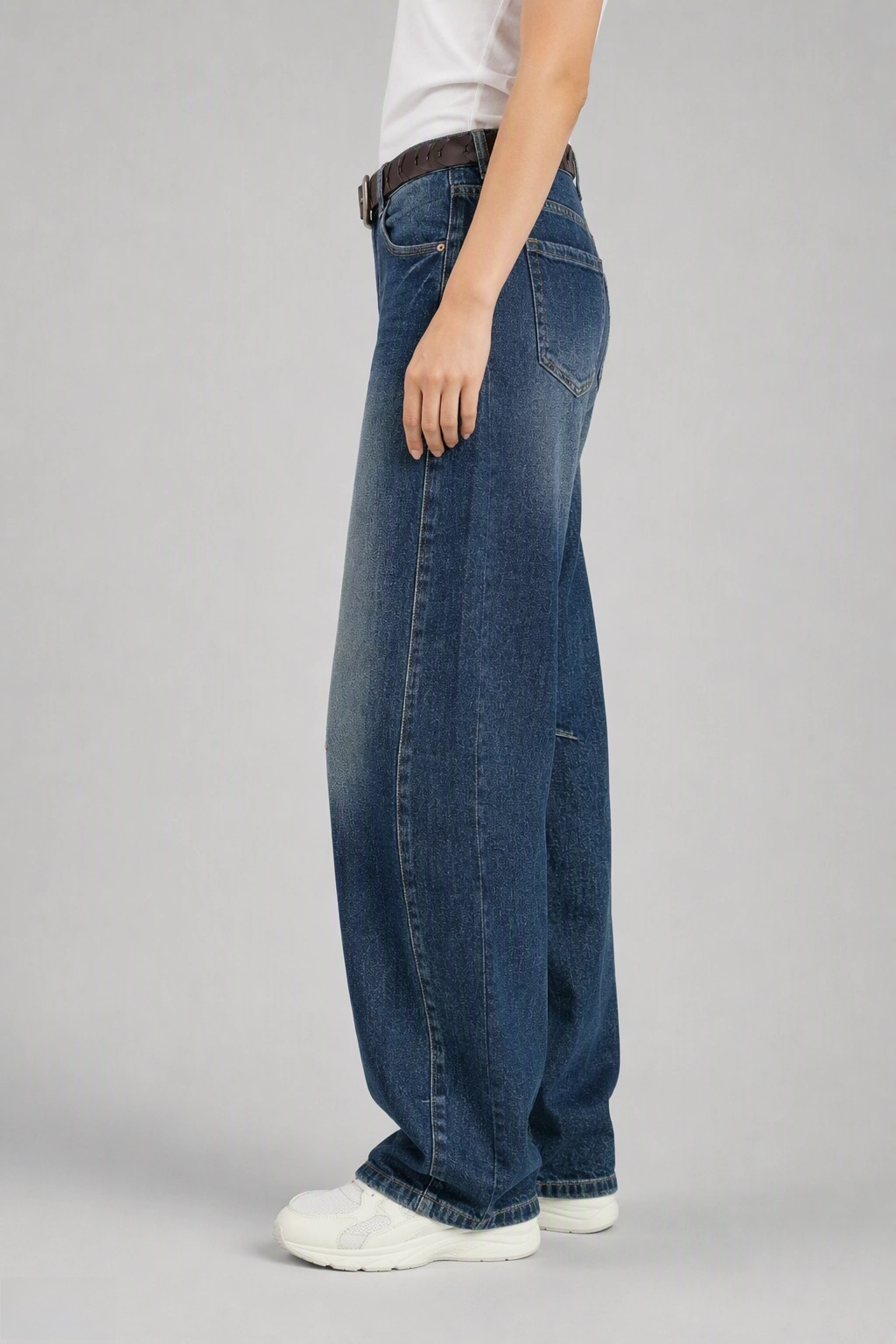 Side view of QAYQEY deep-blue knee-dart curved-leg jeans, showing the curved outseam