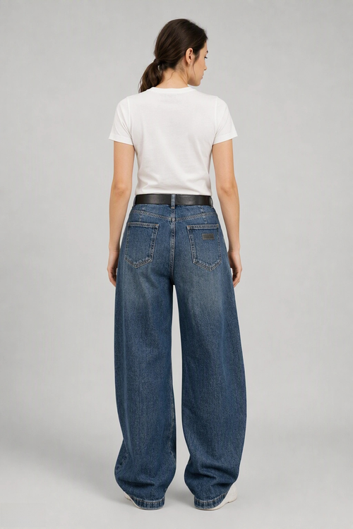 Back view of QAYQEY vintage-blue curved-leg jeans, waist-down crop on model