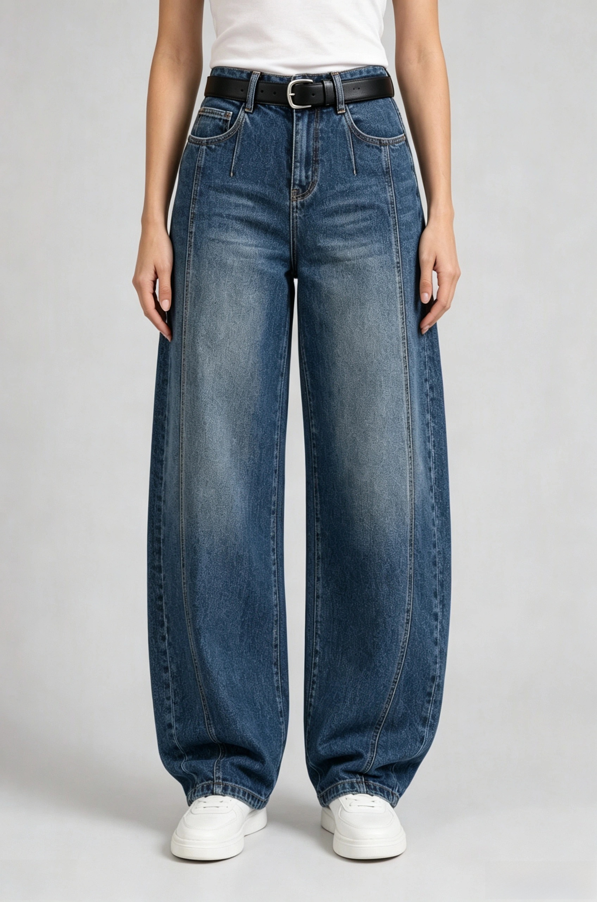 Front view of QAYQEY vintage-blue curved-leg jeans, waist-down crop on model
