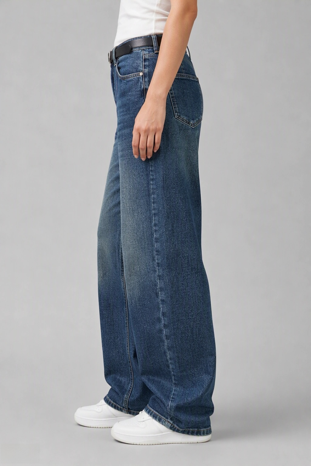Side view of QAYQEY vintage-blue curved-leg jeans, showing the curved outseam