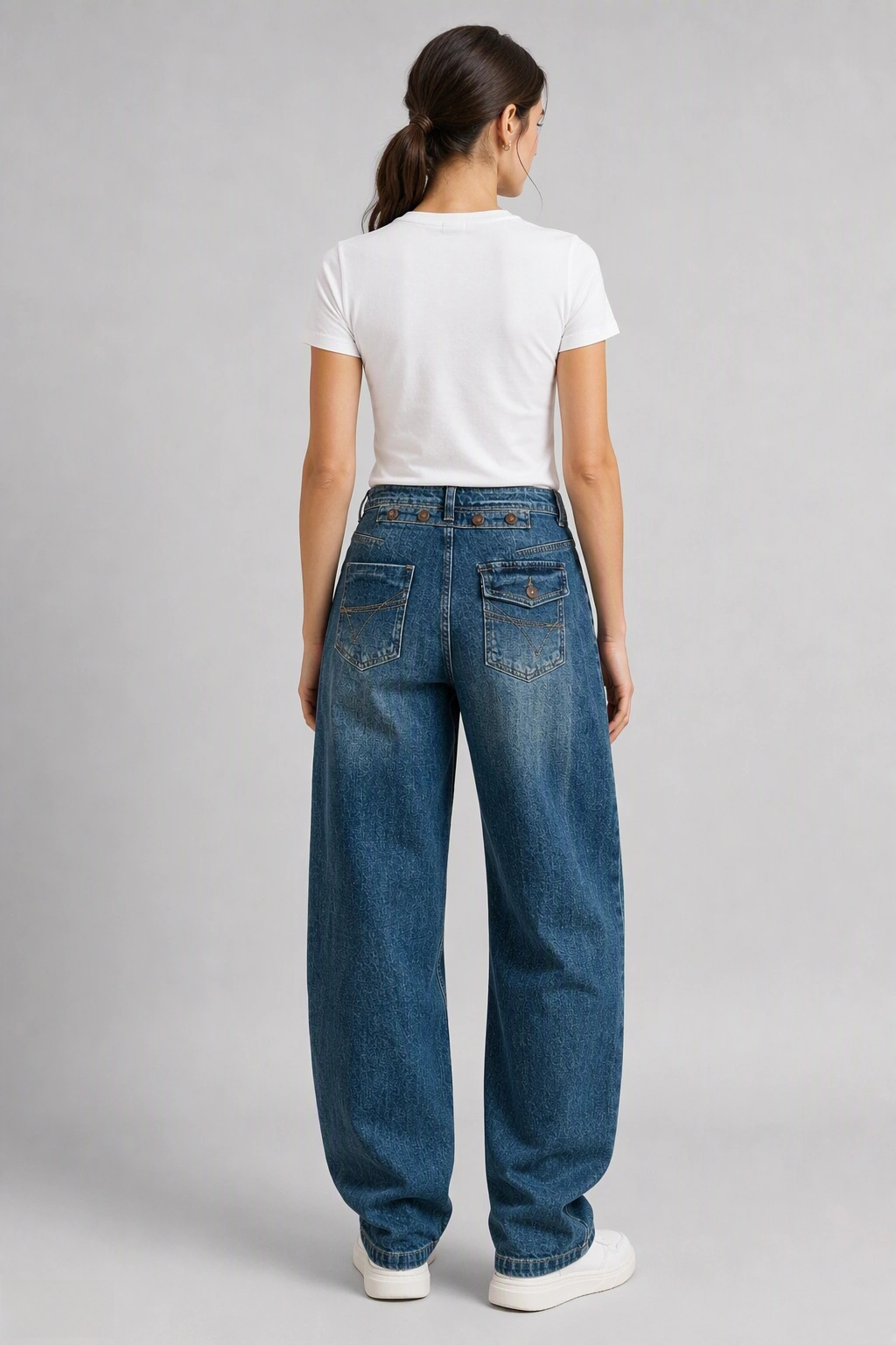 Back view of QAYQEY mid-blue flap-pocket curved-leg jeans, waist-down crop on model