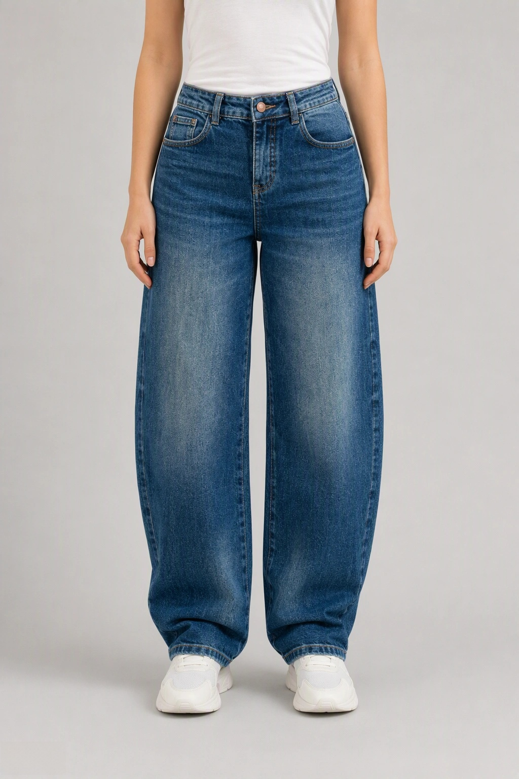 Front view of QAYQEY mid-blue flap-pocket curved-leg jeans, waist-down crop on model