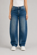 Front view of QAYQEY mid-blue flap-pocket curved-leg jeans, waist-down crop on model