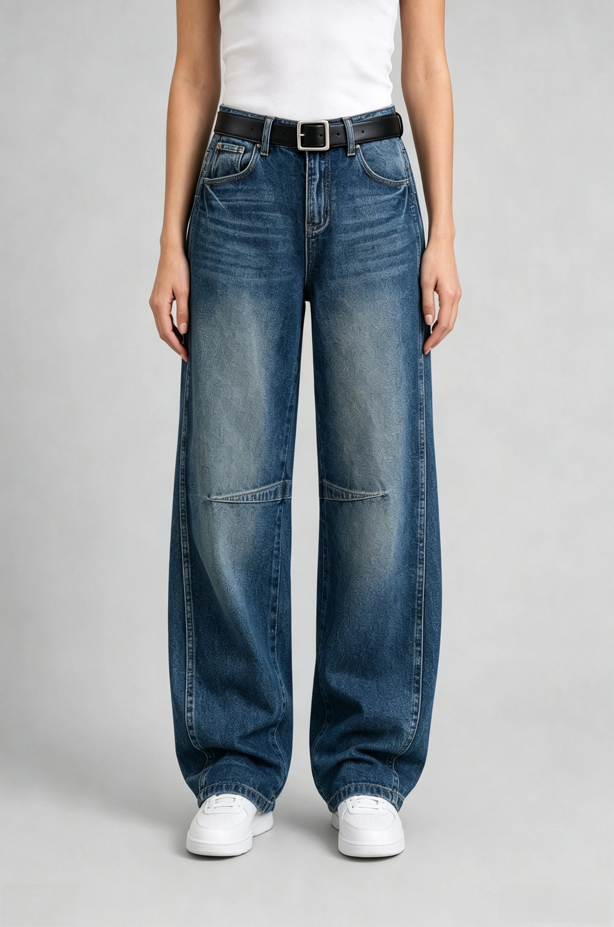 Front view of QAYQEY dark-blue knee-seam curved-leg jeans, waist-down crop on model