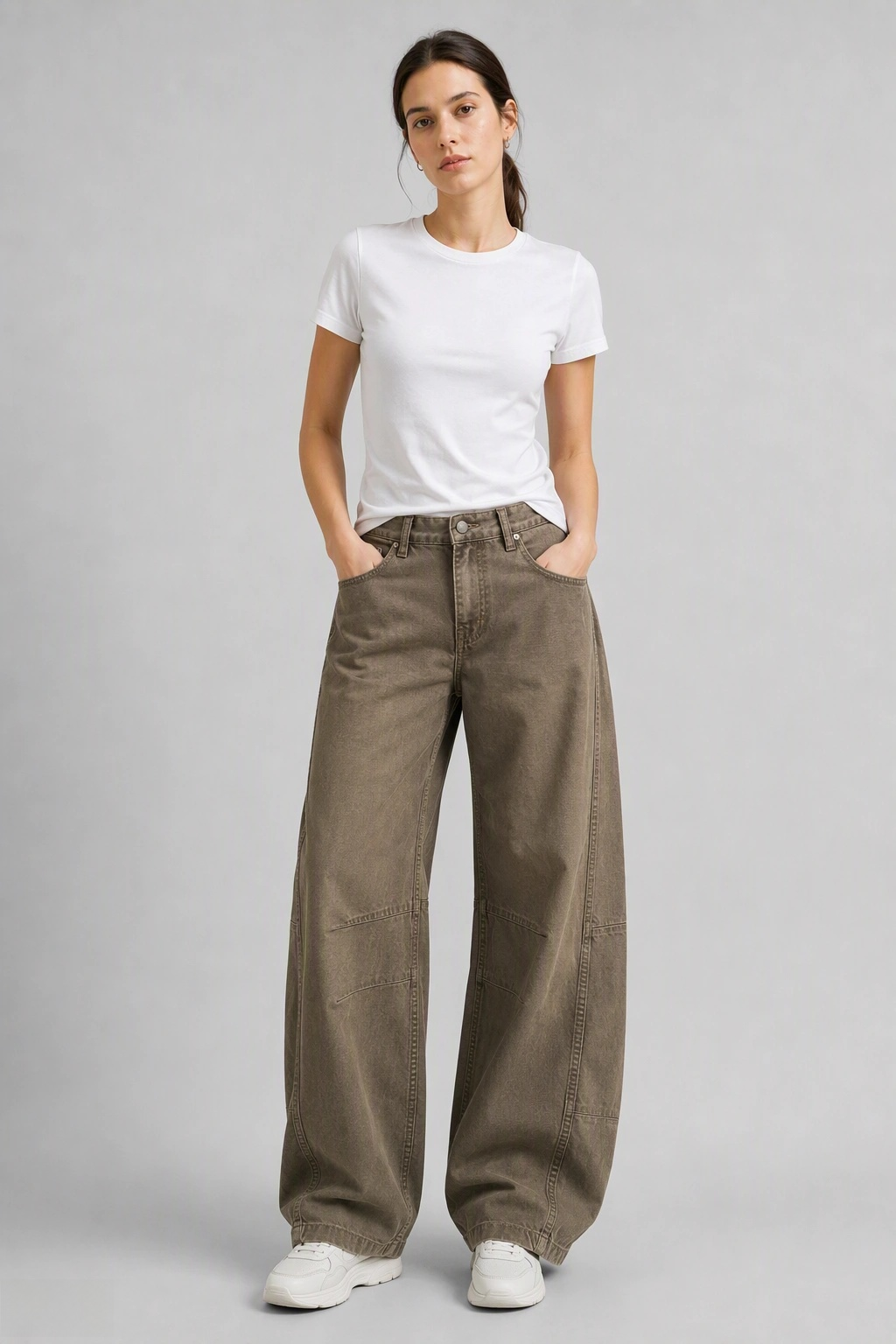 Full-body view of model wearing QAYQEY olive-green curved-leg jeans with a white tee and white sneakers
