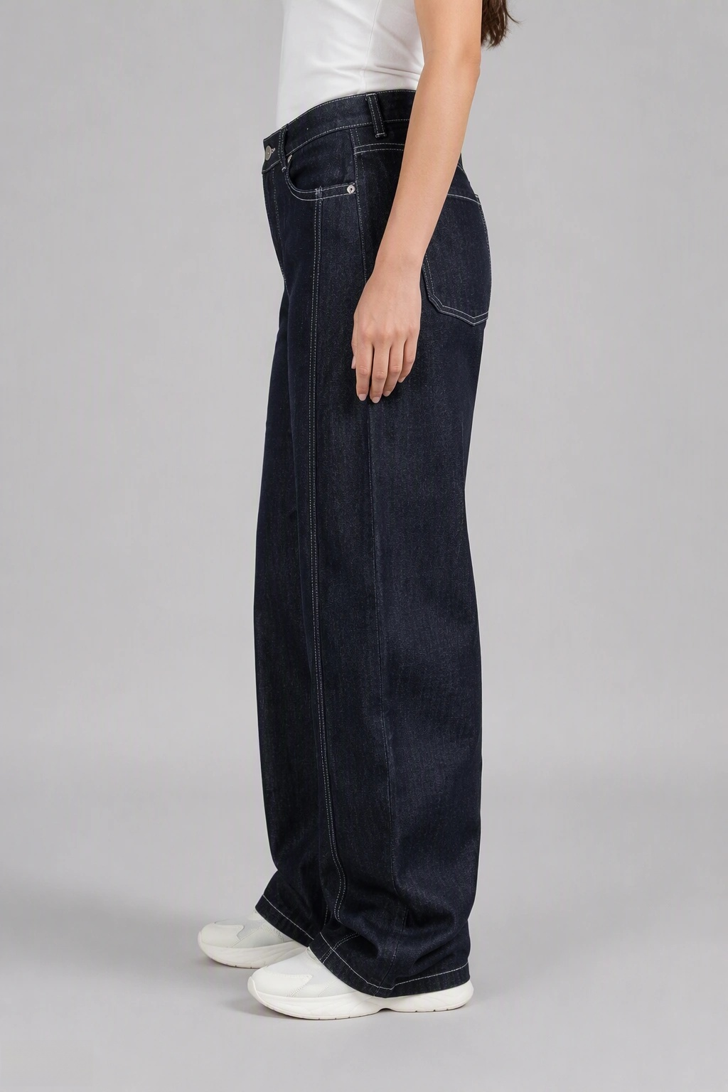 Side view of QAYQEY black-gray curved-leg jeans with contrast stitching, showing the curved outseam