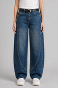 Front view of QAYQEY mid-blue washed curved-leg jeans, waist-down crop on model
