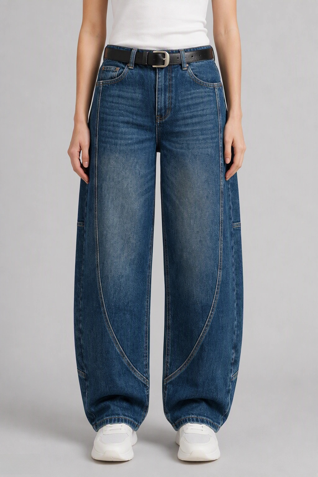 Front view of QAYQEY mid-blue washed curved-leg jeans, waist-down crop on model