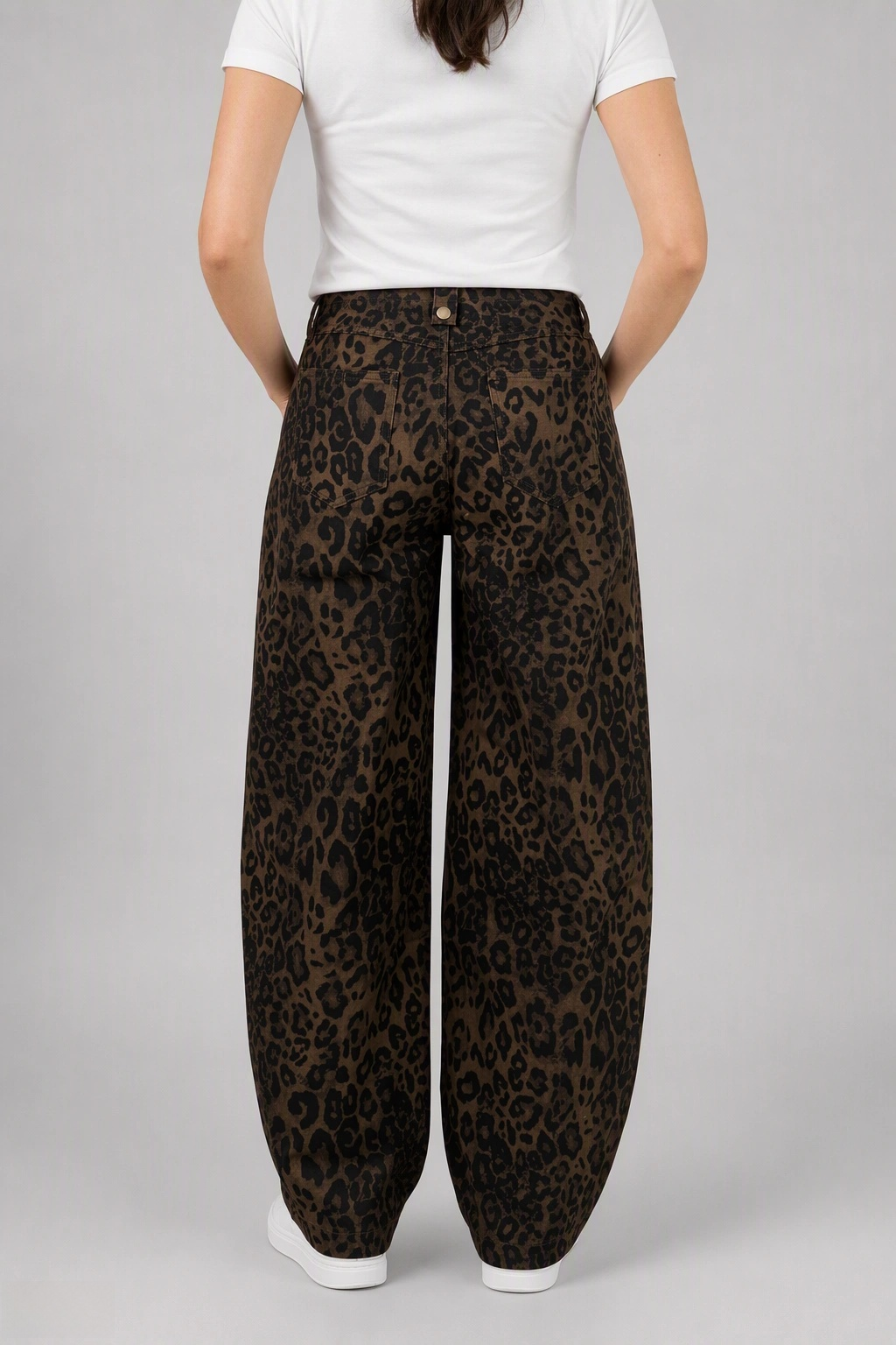 Back view of QAYQEY brown leopard-print curved-leg jeans, waist-down crop on model