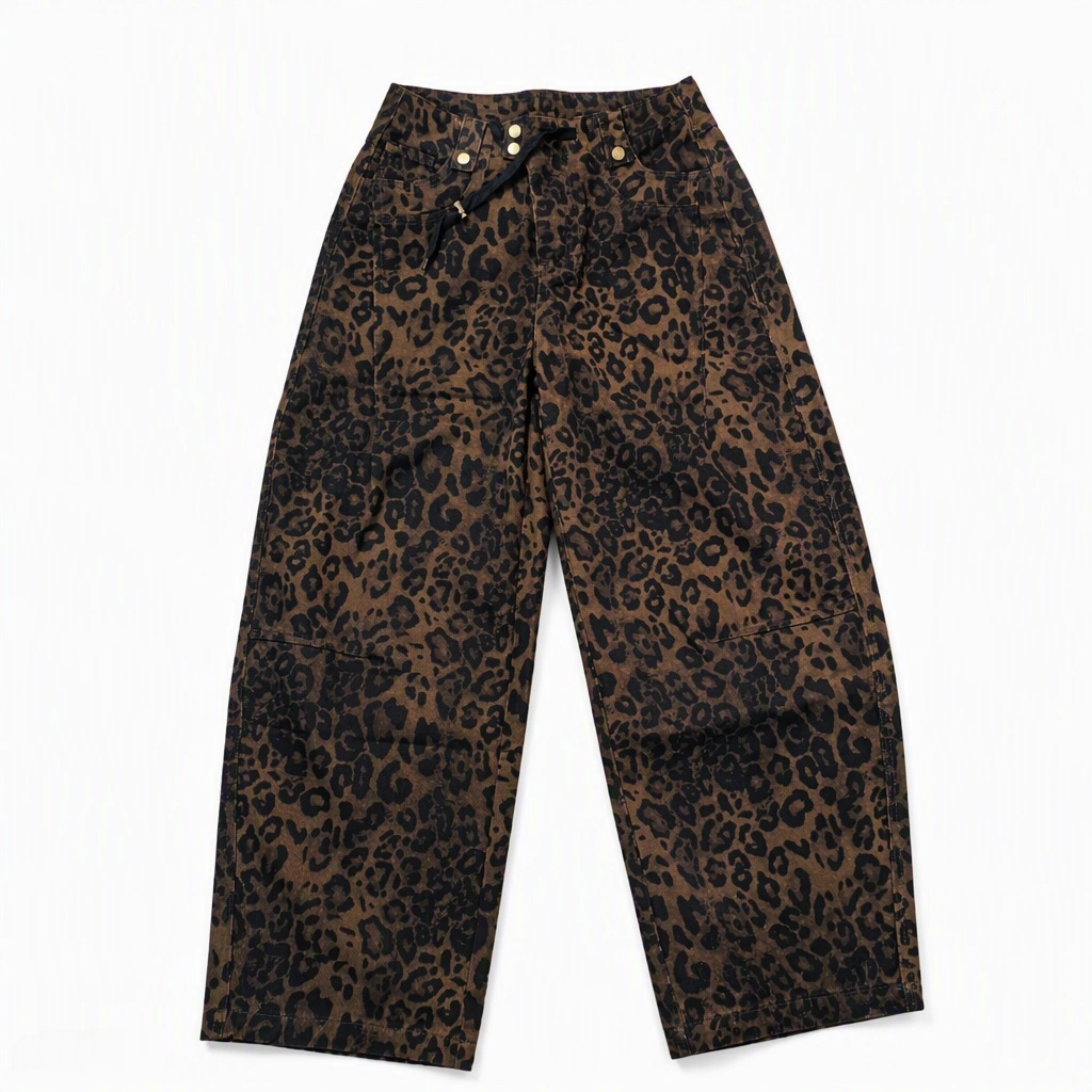 Flat-lay product photo of QAYQEY brown leopard-print curved-leg jeans on a white background