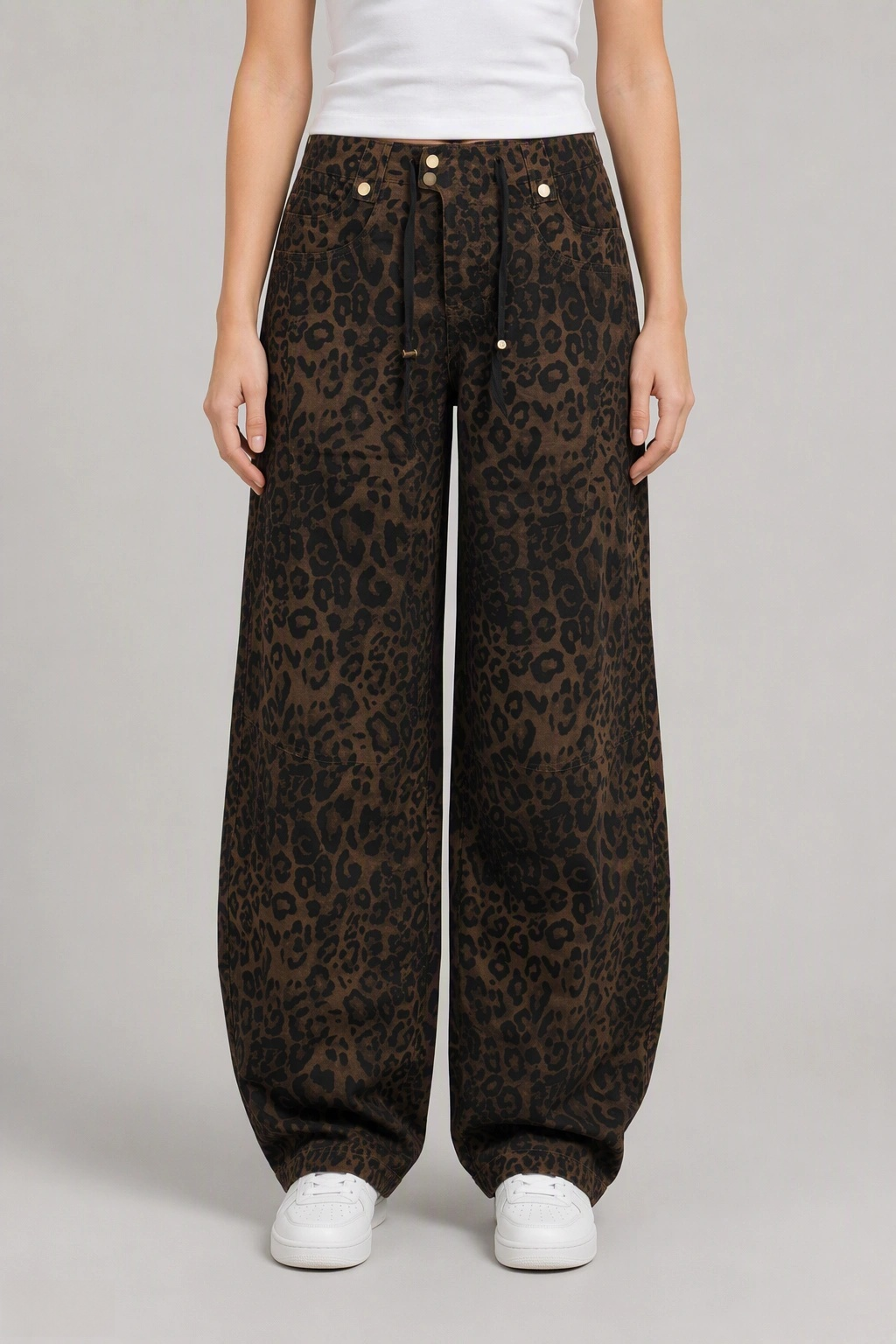 Front view of QAYQEY brown leopard-print curved-leg jeans, waist-down crop on model