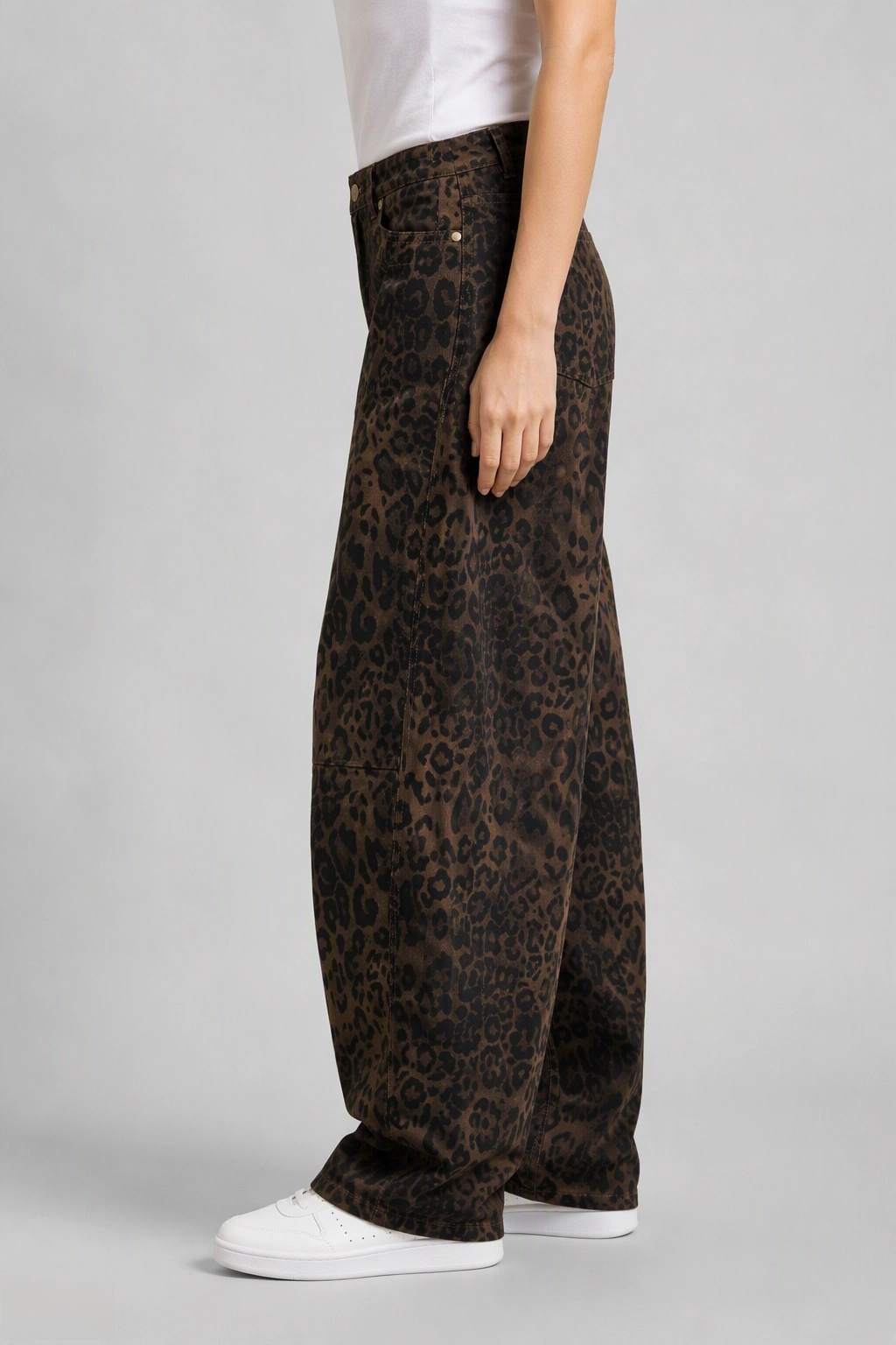 Side view of QAYQEY brown leopard-print curved-leg jeans, showing the curved outseam