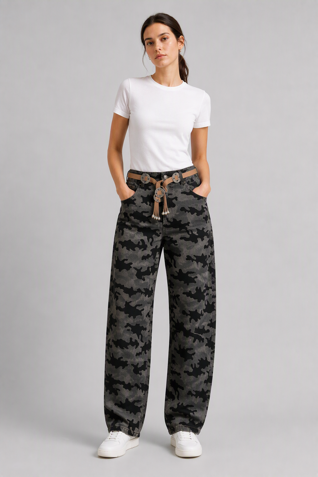 Full-body view of model wearing QAYQEY gray-black camouflage curved-leg jeans with a white tee and white sneakers