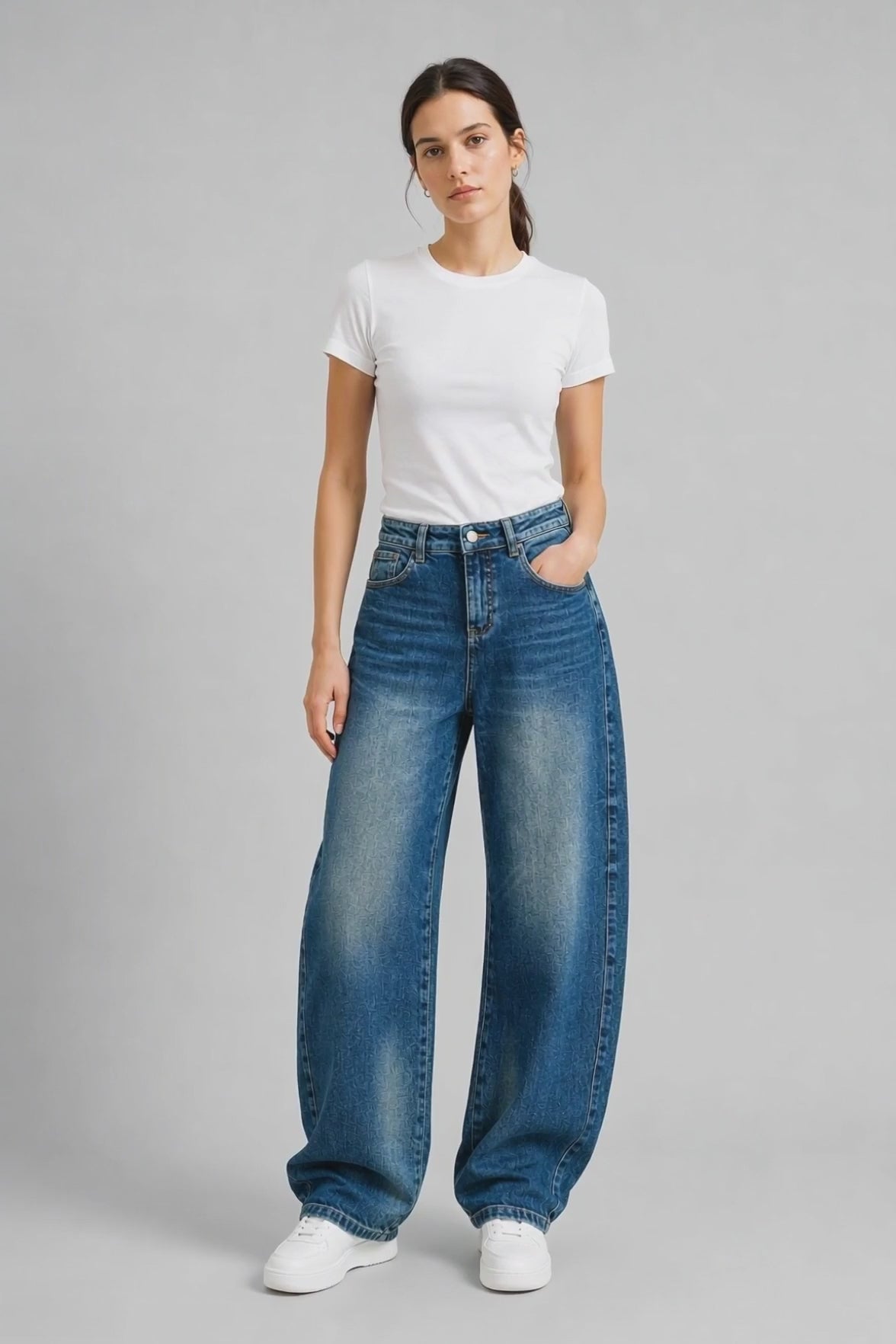 Model wearing Flap-Pocket Curved-Leg Jeans in Mid Blue, walking and turning to show the curved-leg fit and flap pocket detailing.
