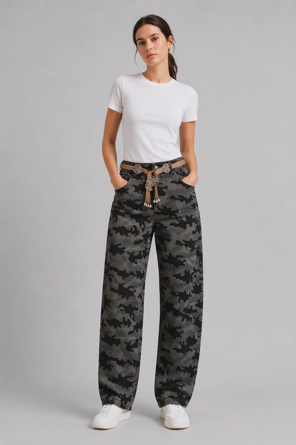 Model wearing Camouflage Curved-Leg Jeans in Gray Black, walking and turning to show the curved-leg fit and all-over camouflage print.