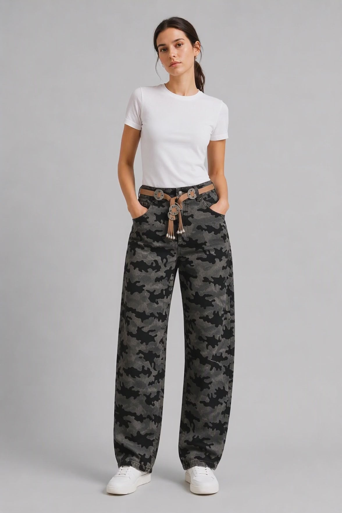Model wearing Camouflage Curved-Leg Jeans in Gray Black, walking and turning to show the curved-leg fit and all-over camouflage print.
