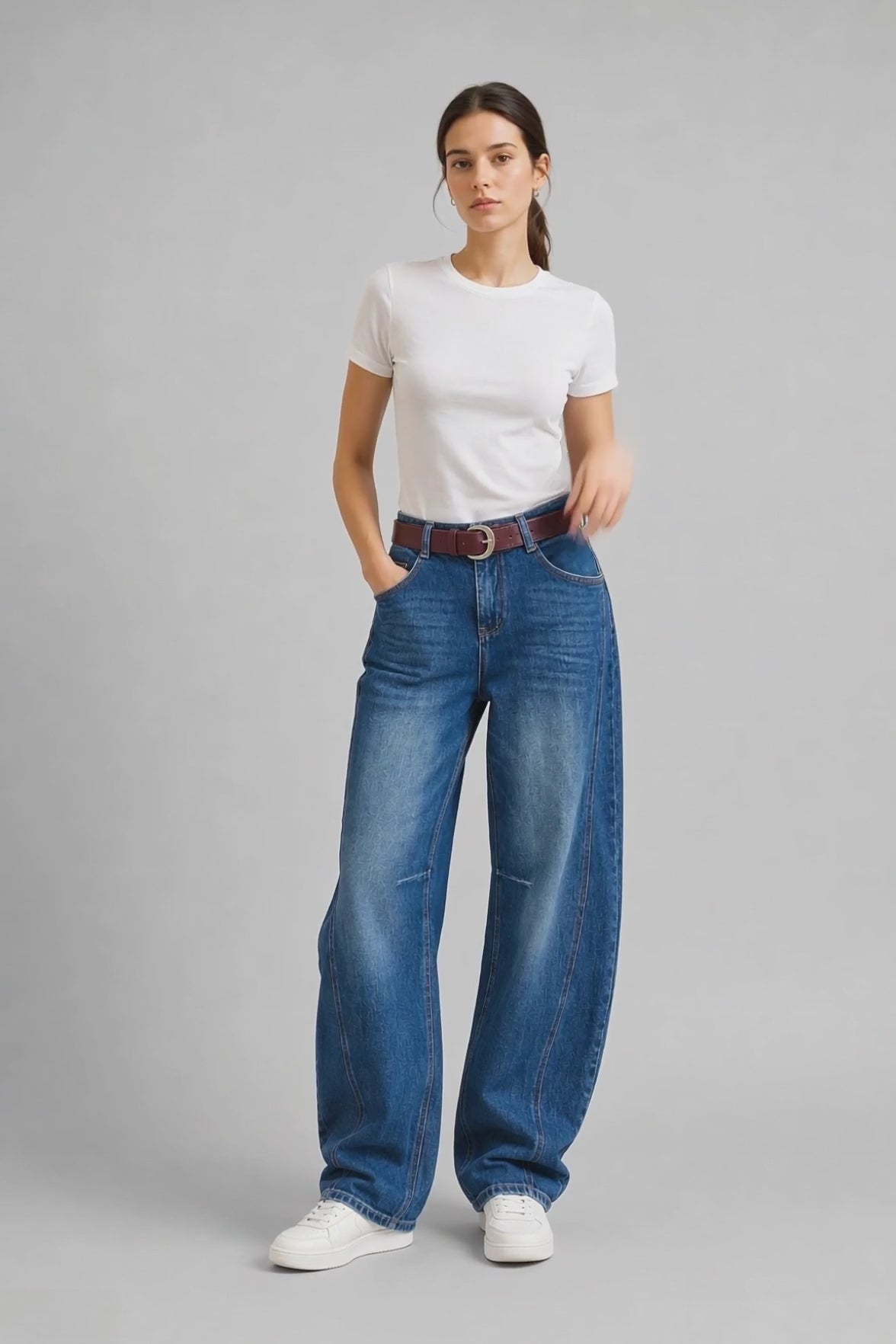 Model wearing Faded Curved-Leg Jeans in Light Blue, walking and turning to show the curved-leg fit and faded wash finish.