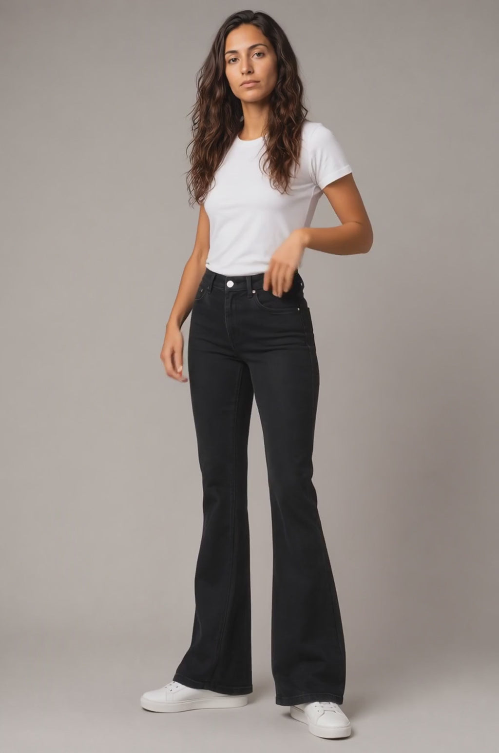 Model wearing Embroidered Bootcut Jeans in Black, walking and turning to show the bootcut fit and embroidered detailing.