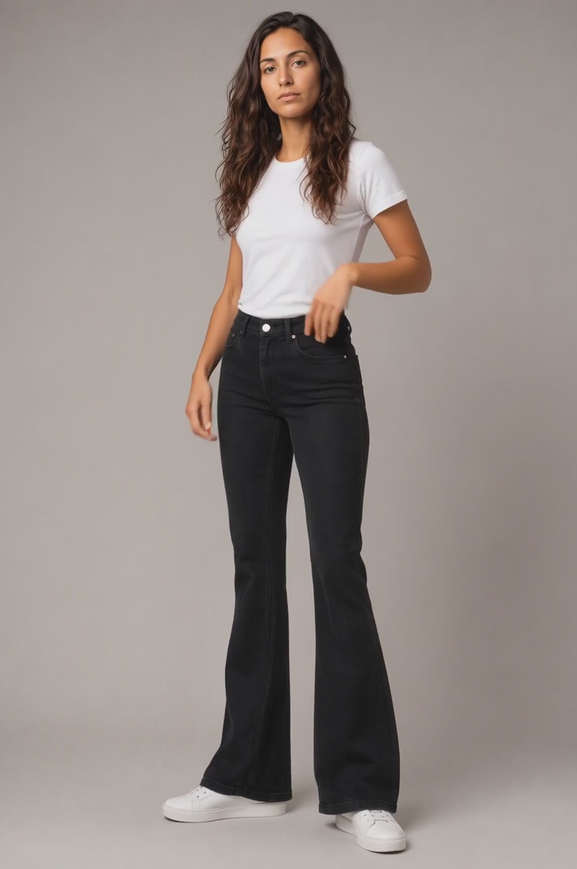 Model wearing Embroidered Bootcut Jeans in Black, walking and turning to show the bootcut fit and embroidered detailing.