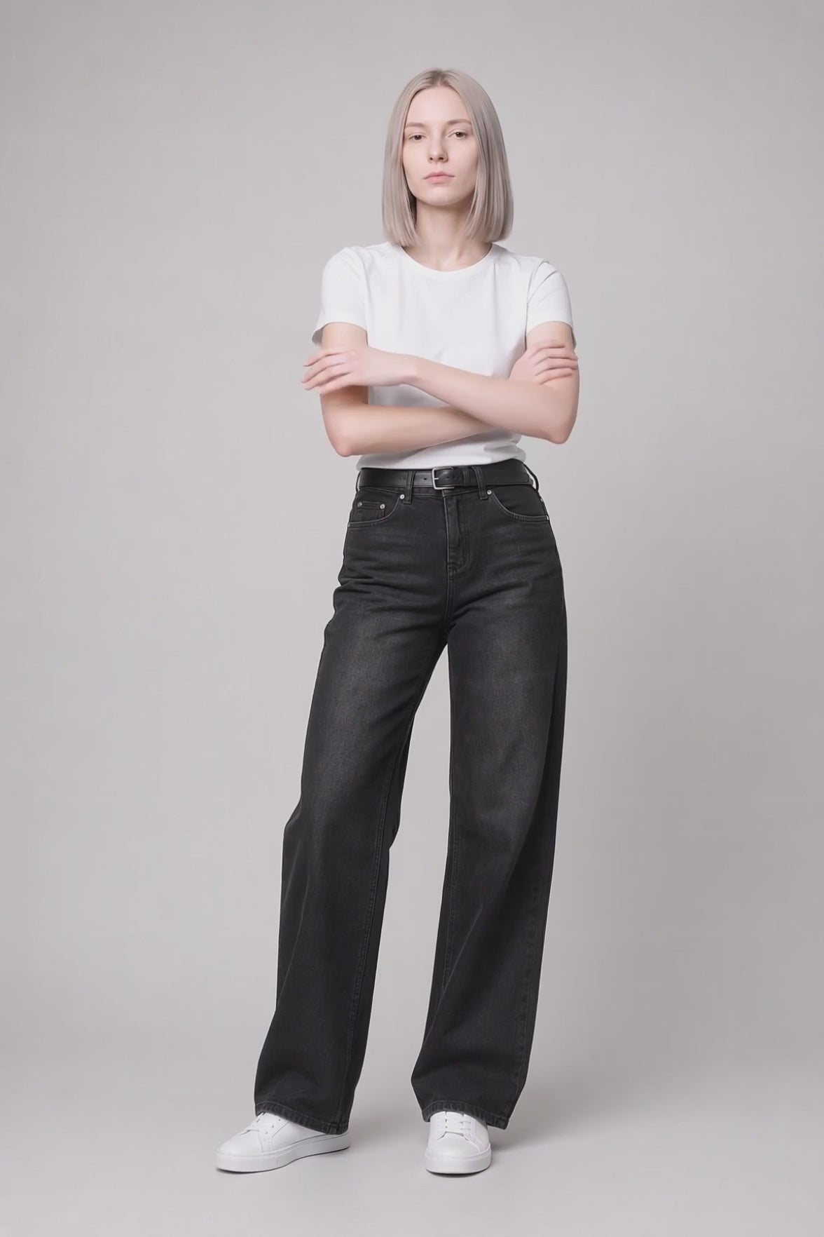 Model wearing Flap-Pocket Straight-Leg Jeans in Black Gray, walking and turning to show the straight-leg fit and flap pocket detailing.