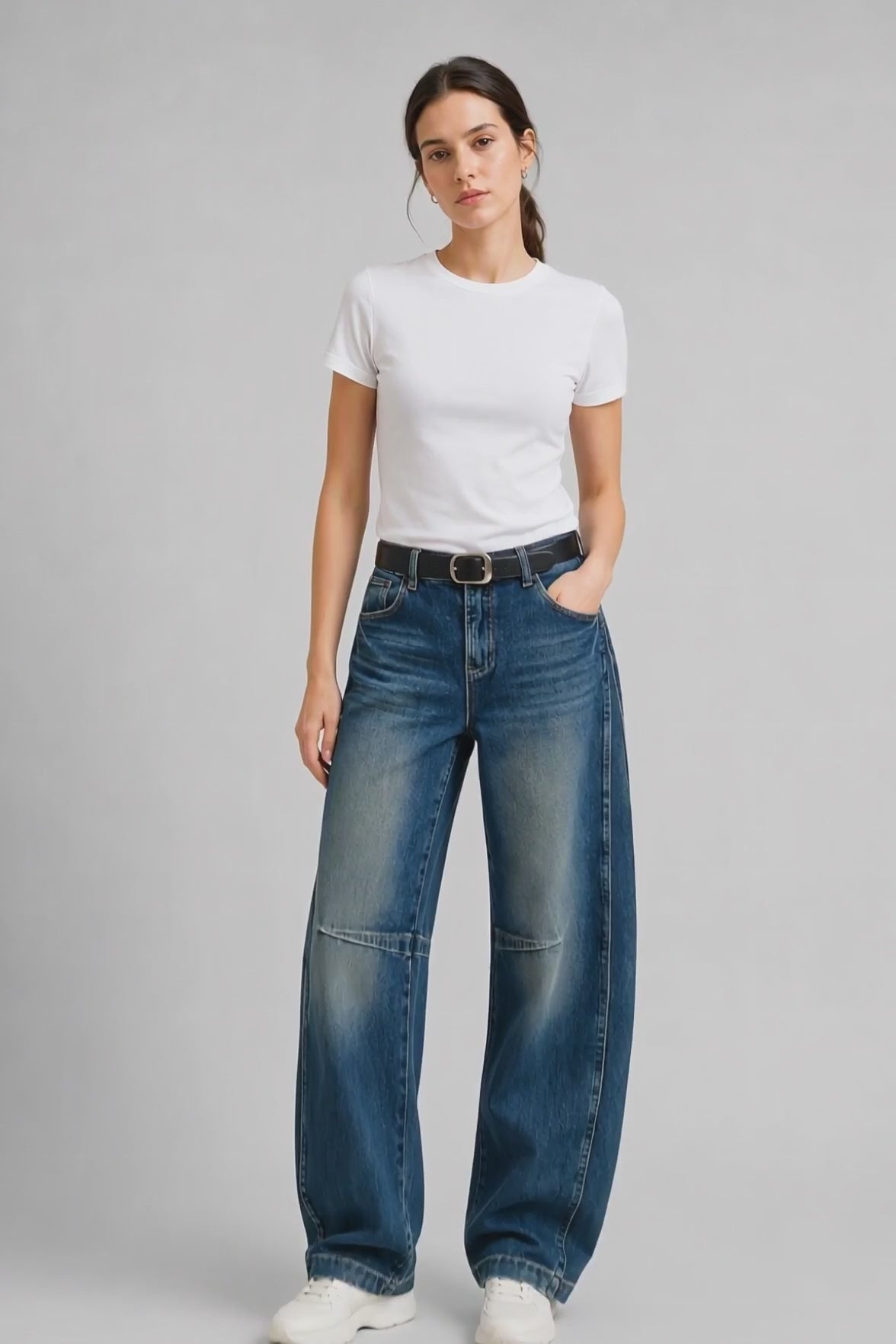 Model wearing Knee-Seam Curved-Leg Jeans in Dark Blue, walking and turning to show the curved-leg fit and knee seam detailing.